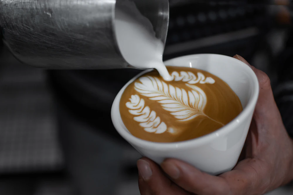 Milk being poured into a cappuccino