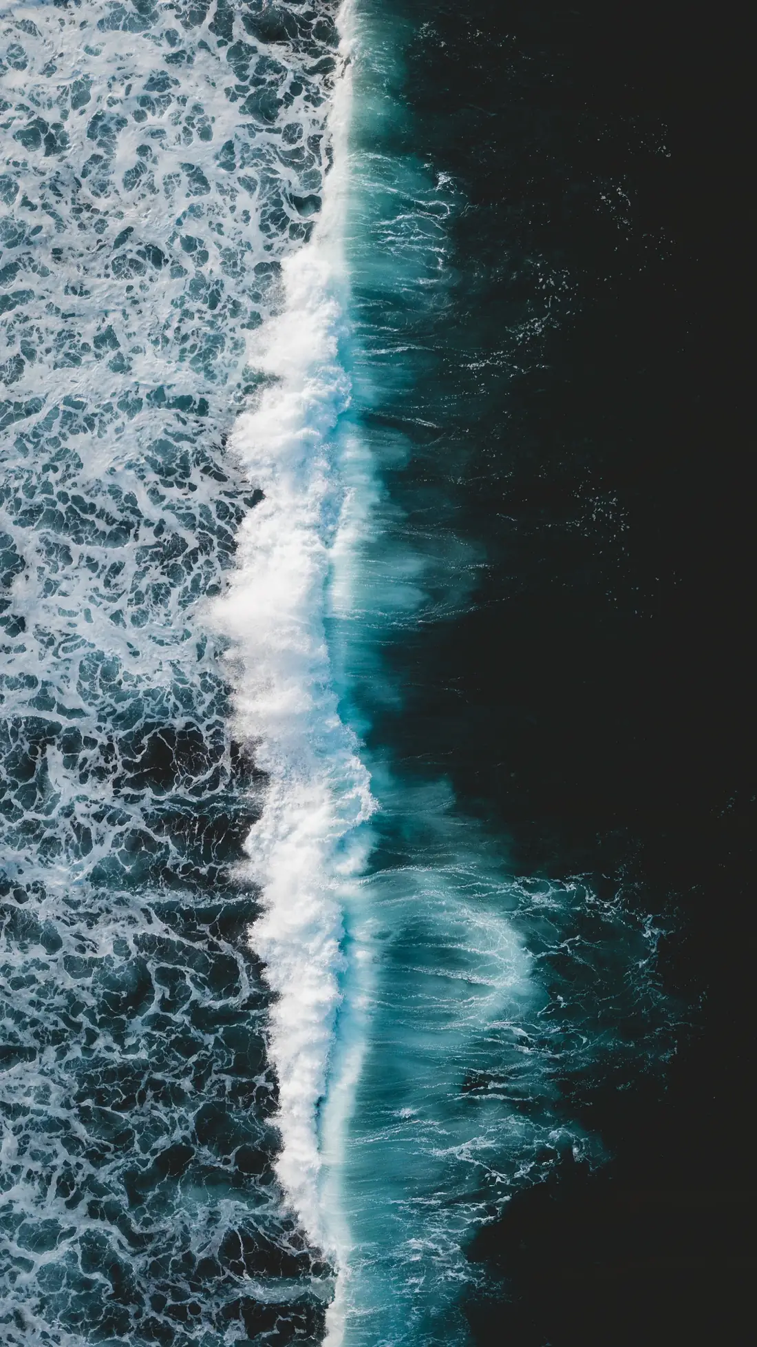 Aerial view of waves breaking on a dark sea